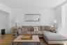 Hardwood flooring, crown molding, and a wide doorway