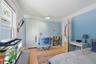 Wood-finish flooring, white trim, recessed lighting, and a paneled door