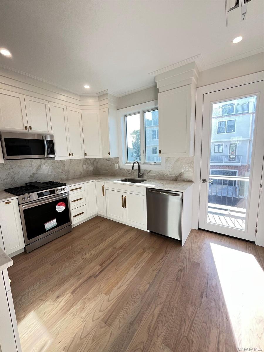 Deck off the kitchen offers the perfect setting for al fresco dining or entertaining.