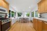 Vaulted ceiling, recessed lighting, wood-finish flooring, white countertops, and stainless steel appliances