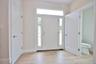 Oversized entry hall with beautiful ceramic tile flooring, 1/2 bath and door out to an oversized 1 car garage.