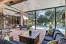Screened patio featuring a swimming pool, red brick-finish flooring, and sliding glass doors