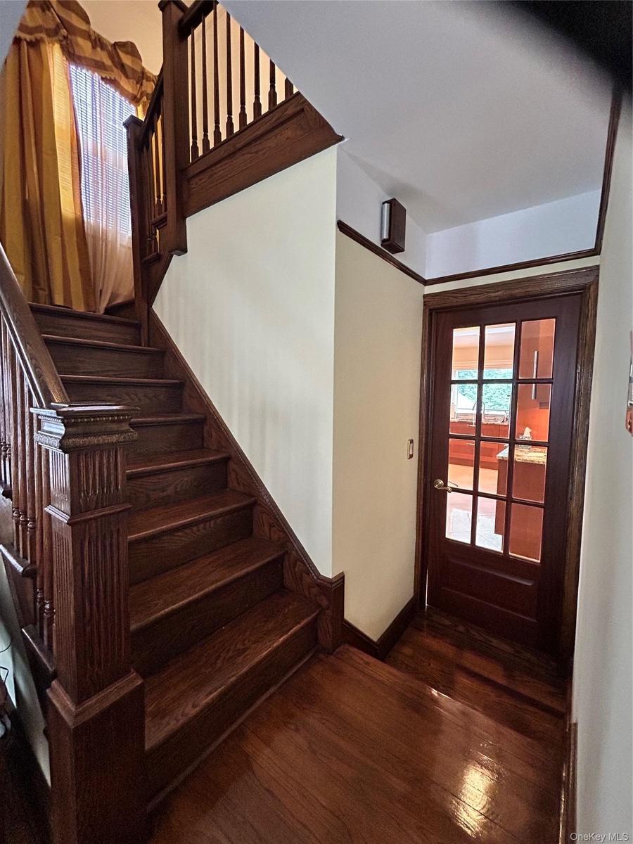 Hardwood flooring and staircase with intricate newel post