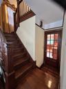 Hardwood flooring and staircase with intricate newel post