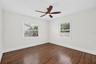 Second bedroom has glistening original oak floors
