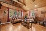 Vaulted wood-finish ceilings with exposed beams, recessed lighting, wood-finish paneling, and wood-finish flooring
