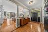 You're barely in the door and immediately you see this is not your average townhome.  Inlaid hardwood floors, crown molding and open space.