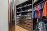 A second primary suite closet with the same custom system.