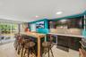 Espresso stained cabinets to hold your barware, a wine refrigerator and a beverage cooler. New floors as well.