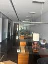 Recessed lighting, linear pendant lighting, dark tile flooring, and glass partition walls
