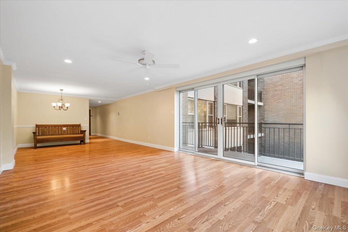 The entry hall leads to a large, sunlit living room with sliding glass doors to private terrace.