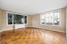 Spacious primary bedroom with large windows and ensuite bathroom.