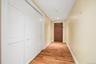 Entry hallway to unit, flanked by floor to ceiling closets.