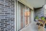 Private patio, with sliding glass doors connecting to living room.