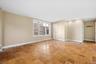 Spacious primary bedroom with large windows and ensuite bathroom.