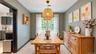 Spacious dining area with light-toned wood-finish flooring