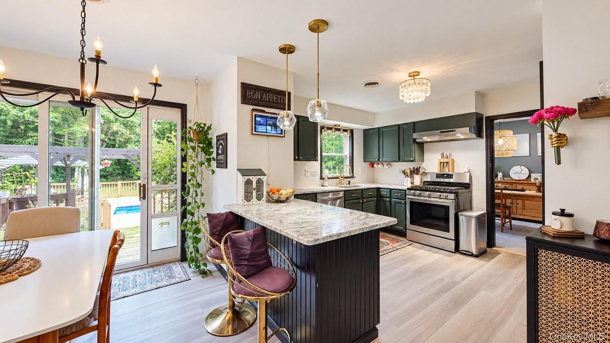 Kitchen featuring a center island with a stone countertop, recessed lighting, and stainless steel appliances