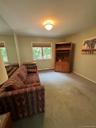 Built-in wooden cabinetry, dual windows, and ceiling-mounted light fixture
