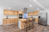Ai generated photo example of kitchen finished with natural cabinetry and counters.
