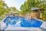 above - ground swimming pool featuring a classic blue interior, vinyl liner construction, and integrated deck decking
