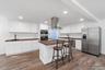 Ai generated photo example of kitchen finished with white cabinetry and dark counters.