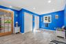 Recessed lighting, wood-finish flooring, French doors with divided lites, built-in storage bench, and a window with trim
