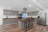 Ai generated photo example of kitchen finished with grey cabinetry and dark counters.