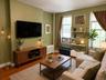 Hardwood-style flooring throughout this living space (virtually staged)