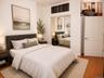 Bedroom featuring wood-finish flooring and a neutral color palette(virtually staged)