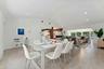 Open-concept living space featuring a wood-finish plank floor throughout, recessed ceiling lighting, and seamless integration of dining and kitchen ar