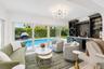 Living area with wood-finish flooring, built-in cabinetry, and integrated beverage coolers