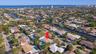 Aerial perspective of a neighborhood featuring residential properties, waterways, and distant coastal waters