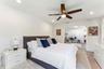 Spacious sleeping area featuring wood-finish flooring, recessed lighting, and a ceiling fan with integrated lighting