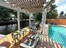 Waterfront pool + pergola + tiki bar (off to the right)