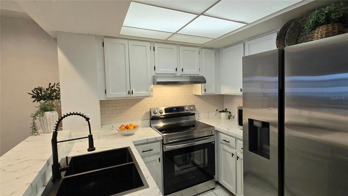 There is a walk-in pantry in addition to the kitchen cabinets for more storage.