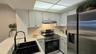 There is a walk-in pantry in addition to the kitchen cabinets for more storage.