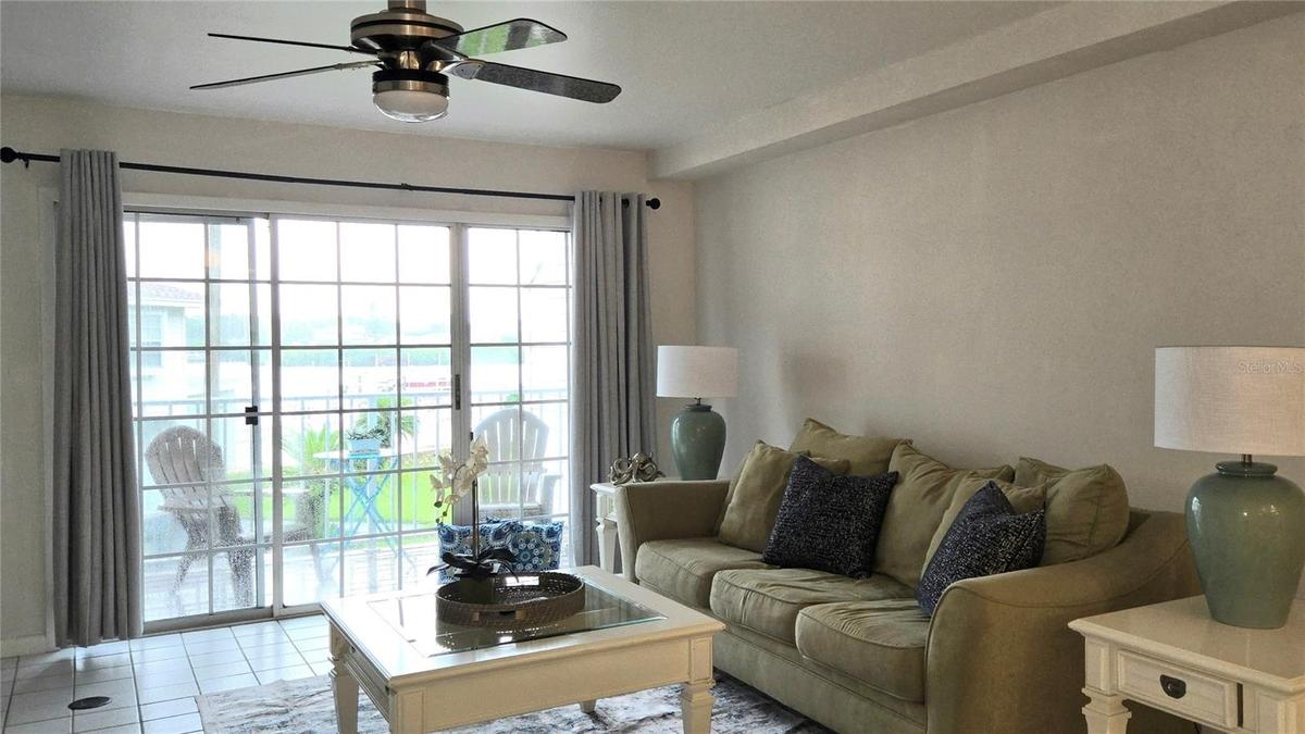 Living Room has sliding doors to a Private Deck overlooking the pool and waterfront.