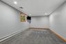 Recessed lighting, wood-trimmed window, gray carpeting, neutral wall color, and wood baseboards