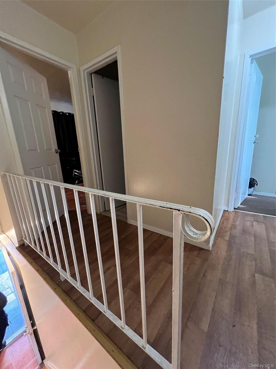 Stairs with wood finished floors and baseboards