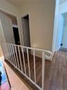 Stairs with wood finished floors and baseboards