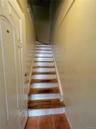 Stairway featuring tile patterned floors and baseboards