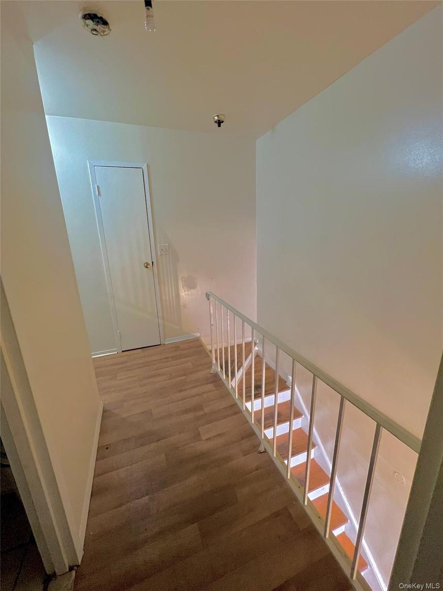Staircase featuring wood finished floors and baseboards