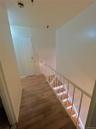 Staircase featuring wood finished floors and baseboards