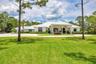 Ranch-style residence featuring a metal roof and a circular drive