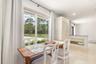 Dining area featuring large sliding glass doors, recessed lighting, and a half-wall partition