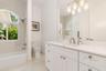 Vanity area featuring a dual sink with a white countertop and brushed nickel fixtures