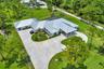 Spacious single-story residence with a metal roof and a circular drive