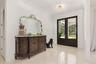 Double entry doors with glass panels and dark wood framing