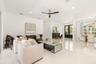 Expansive living area with high ceilings, recessed lighting.