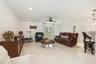 Spacious living area featuring polished marble flooring, recessed lighting, and a ceiling fan